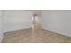 An empty living room shows tile flooring, fresh white paint, and recessed lighting at 5200 Malaga Ave, Sarasota, FL 34235