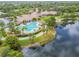 Aerial view of a beautiful community clubhouse, pool, and lakeside scenery at 5368 Eliseo St, Sarasota, FL 34238