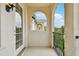 Balcony view of exterior architecture through arched opening; black railing at 5368 Eliseo St, Sarasota, FL 34238