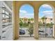 Balcony view between two arches of neighborhood homes and blue sky above at 5368 Eliseo St, Sarasota, FL 34238