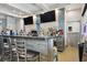 The well-stocked bar area features modern appliances, tiled walls, televisions, and seating at 5368 Eliseo St, Sarasota, FL 34238