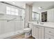 Bathroom features white cabinets and countertops, framed mirror, and glass enclosed shower at 5368 Eliseo St, Sarasota, FL 34238