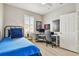 Well-lit bedroom featuring a twin bed, study desk, and natural light from the shuttered window at 5368 Eliseo St, Sarasota, FL 34238