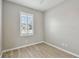Bright, unfurnished bedroom with wood-look floors and natural light from a shuttered window at 5368 Eliseo St, Sarasota, FL 34238