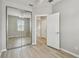 Neutral bedroom featuring wood-look floors and sliding mirror closet doors at 5368 Eliseo St, Sarasota, FL 34238