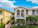 Inviting home exterior with double balconies, arched windows, and well-maintained landscaping at 5368 Eliseo St, Sarasota, FL 34238