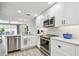 Updated kitchen featuring stainless steel appliances, stone countertops, and seamless views to the patio at 5368 Eliseo St, Sarasota, FL 34238