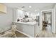 Modern kitchen showcasing white cabinetry, stainless steel appliances, and a breakfast bar next to the dining area at 5368 Eliseo St, Sarasota, FL 34238