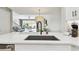 Bright kitchen with stone countertop and black sink overlooking open concept dining and living area at 5368 Eliseo St, Sarasota, FL 34238
