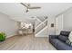 Open-concept living space with stairs, dining area, featuring light-colored wood flooring and neutral wall paint at 5368 Eliseo St, Sarasota, FL 34238
