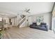 Open-concept living room with tile floors, a staircase, and an adjacent dining area at 5368 Eliseo St, Sarasota, FL 34238