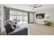 Open living room with tile floors, a ceiling fan, and access to a patio at 5368 Eliseo St, Sarasota, FL 34238