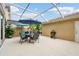 Enclosed patio area with a grill, dining set, and leafy plants for relaxation and outdoor dining at 5368 Eliseo St, Sarasota, FL 34238
