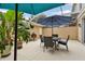 Outdoor patio with a dining set, lush potted plants, and a grill, perfect for outdoor living at 5368 Eliseo St, Sarasota, FL 34238