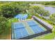 Overhead view of pickleball and basketball courts surrounded by greenery in a beautiful community at 5368 Eliseo St, Sarasota, FL 34238