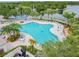A gorgeous community pool surrounded by lush landscaping and set against the backdrop of a tranquil lake at 5368 Eliseo St, Sarasota, FL 34238