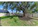 Spacious fenced backyard with a large tree providing ample shade and a well-maintained lawn at 5508 83Rd E Ter, Sarasota, FL 34243