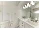 Bright bathroom with double vanity, elegant lighting, and a glass-enclosed shower at 5508 83Rd E Ter, Sarasota, FL 34243