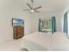 Sunlit bedroom featuring white marble floors, ceiling fan, and window view of the outdoors at 5508 83Rd E Ter, Sarasota, FL 34243