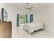 Bright bedroom with white marble floors, ceiling fan, and sliding glass door leading to the backyard at 5508 83Rd E Ter, Sarasota, FL 34243