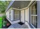 Inviting front entrance with stylish gray trim and a tiled porch at 5508 83Rd E Ter, Sarasota, FL 34243