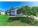 Beautifully landscaped front yard of a home with lush green grass at 5508 83Rd E Ter, Sarasota, FL 34243