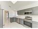 Spacious kitchen featuring stainless steel appliances, gray cabinetry and sleek white marble flooring at 5508 83Rd E Ter, Sarasota, FL 34243