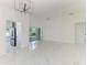 Bright and spacious living room flowing to kitchen, complete with modern lighting at 5508 83Rd E Ter, Sarasota, FL 34243