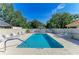 Inviting community pool with lounge chairs and umbrellas for relaxation under a clear blue sky at 5508 83Rd E Ter, Sarasota, FL 34243