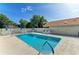 Beautiful community pool surrounded by lounge chairs, umbrellas, and well-manicured landscaping at 5508 83Rd E Ter, Sarasota, FL 34243