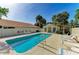 Inviting community pool with ample lounge chairs, palm trees, and a nearby pool house at 5508 83Rd E Ter, Sarasota, FL 34243