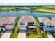 Aerial view of a lakeside home with lush green surroundings in a peaceful neighborhood at 5644 Flagstone Trl, Palmetto, FL 34221