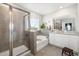Spa-like bathroom with soaking tub, glass-enclosed shower, and granite vanity at 5644 Flagstone Trl, Palmetto, FL 34221