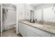 Bright bathroom featuring double sinks with granite countertops and modern fixtures at 5644 Flagstone Trl, Palmetto, FL 34221