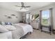 Comfortable bedroom with ample natural light, TV, a ceiling fan, and neutral décor at 5644 Flagstone Trl, Palmetto, FL 34221