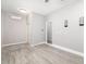 Spacious bedroom with wood-look flooring, neutral walls, and a mini split air conditioner at 5644 Flagstone Trl, Palmetto, FL 34221