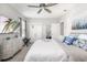 Bedroom suite with a plush bed, TV, and abundant natural light from the windows at 5644 Flagstone Trl, Palmetto, FL 34221