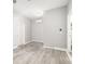 Versatile room with wood-look flooring, neutral walls, and a mini split air conditioner at 5644 Flagstone Trl, Palmetto, FL 34221