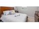 Cozy bedroom with a large bed, wooden headboard, and neutral color scheme at 5644 Flagstone Trl, Palmetto, FL 34221