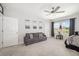 Spacious bedroom featuring a comfortable seating area and large windows for natural light at 5644 Flagstone Trl, Palmetto, FL 34221