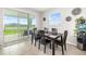 Bright dining room with access to outdoor patio and view of the lake at 5644 Flagstone Trl, Palmetto, FL 34221