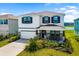 Beautiful two-story home with a well-manicured lawn, a covered porch, and a two-car garage at 5644 Flagstone Trl, Palmetto, FL 34221