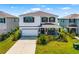 Charming two-story home featuring a landscaped yard, covered porch, and two-car garage at 5644 Flagstone Trl, Palmetto, FL 34221