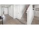 Entryway featuring tile flooring, staircase, and a view to the front door and living area at 5644 Flagstone Trl, Palmetto, FL 34221