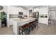Kitchen island with stone countertop, modern appliances and seating at 5644 Flagstone Trl, Palmetto, FL 34221