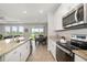 Open kitchen and living area featuring an island and views of the backyard at 5644 Flagstone Trl, Palmetto, FL 34221