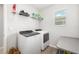 Well-lit laundry room with modern appliances and ample shelving for storage, with a window at 5644 Flagstone Trl, Palmetto, FL 34221