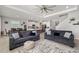 Open-concept living room with modern decor, a view of the kitchen, and an airy atmosphere at 5644 Flagstone Trl, Palmetto, FL 34221