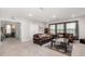 Spacious living room featuring plush leather seating and a cozy rug on neutral carpeting at 5644 Flagstone Trl, Palmetto, FL 34221