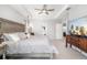 Bright and airy main bedroom featuring luxurious bedding, fan, and neutral walls at 5644 Flagstone Trl, Palmetto, FL 34221